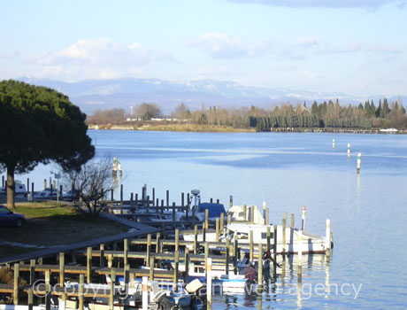 Boats in the lagoon of Grado island photo