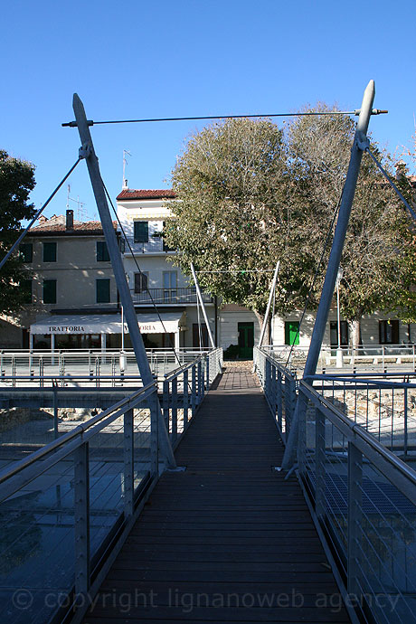 Glass bridge across the ancient ruins at Grado photo